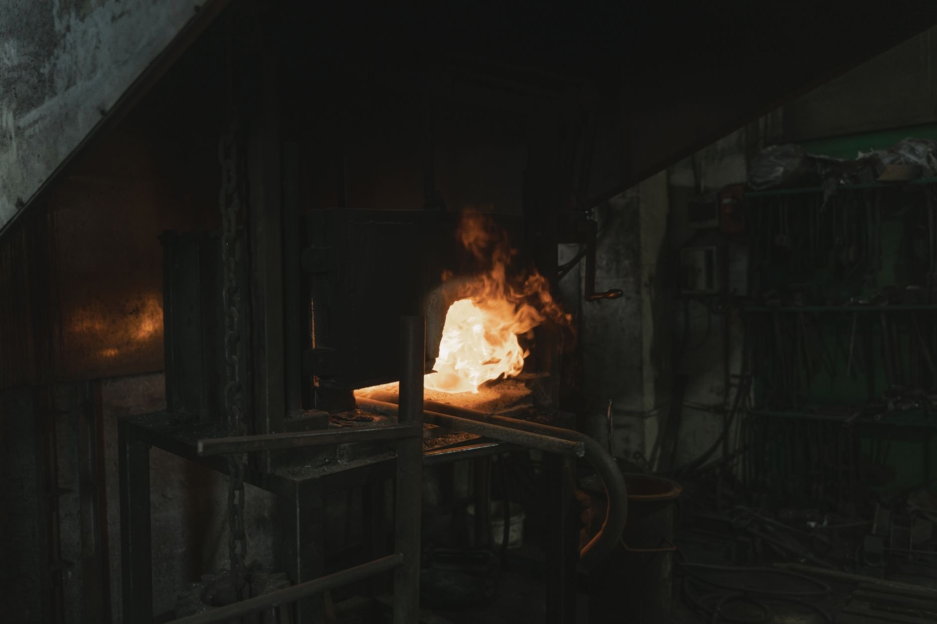 A vibrant scene of an industrial forge with glowing metal and fierce flames, showcasing metalworking.